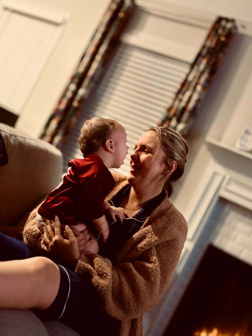 Cassidy and baby by the fireplace